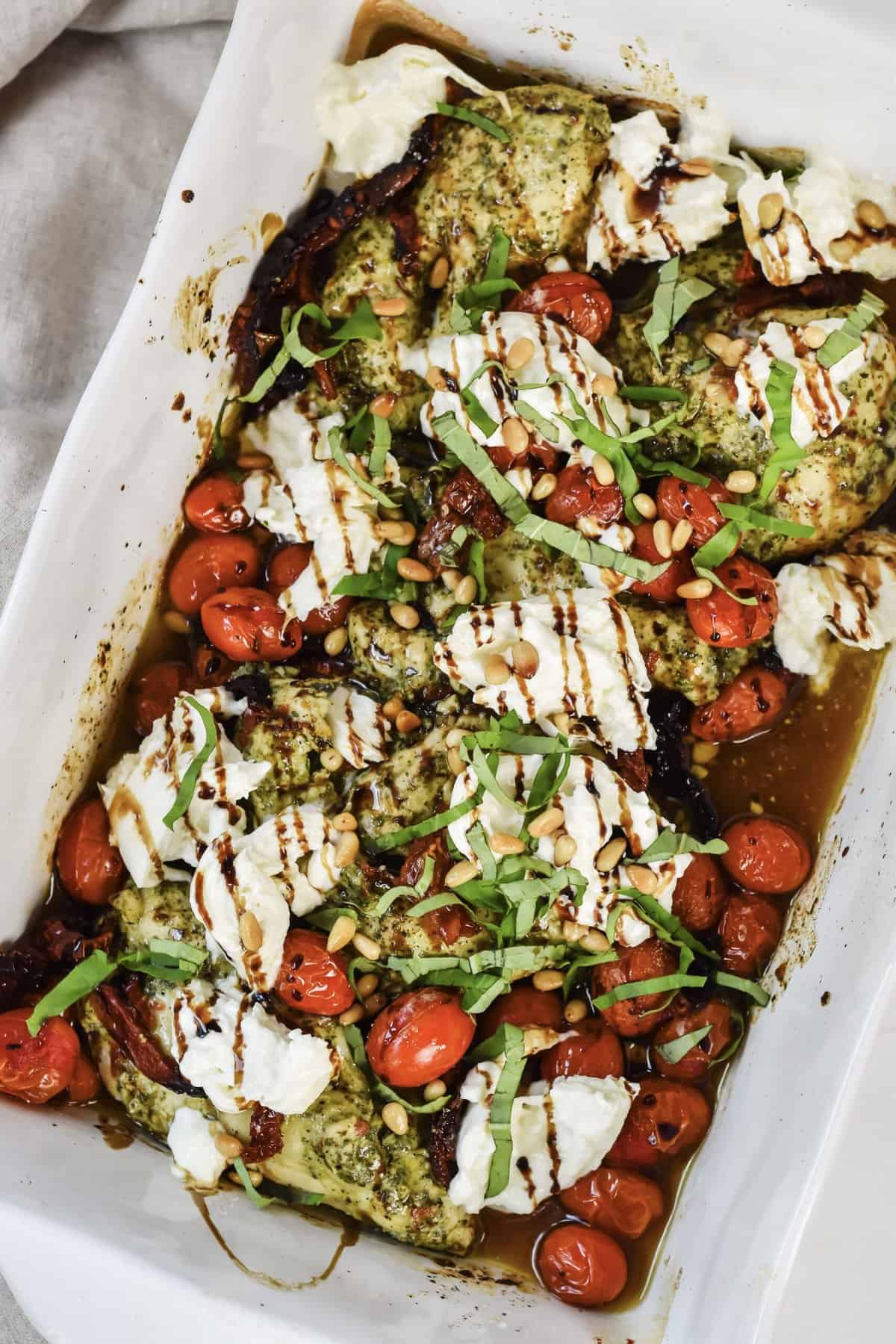 this is the finished trader joe's pesto chicken recipe in the ceramic dish after I have topped it with everything and before I served it on a plate. 