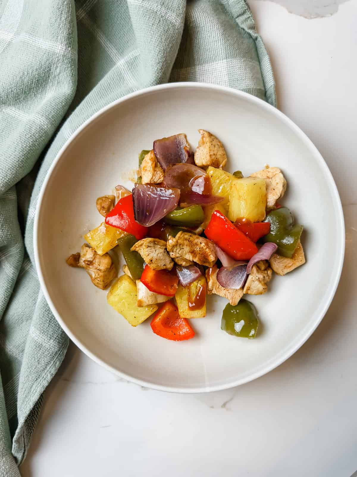 This is a top view of my cooked Hawaiian sheet pan chicken in a bowl 