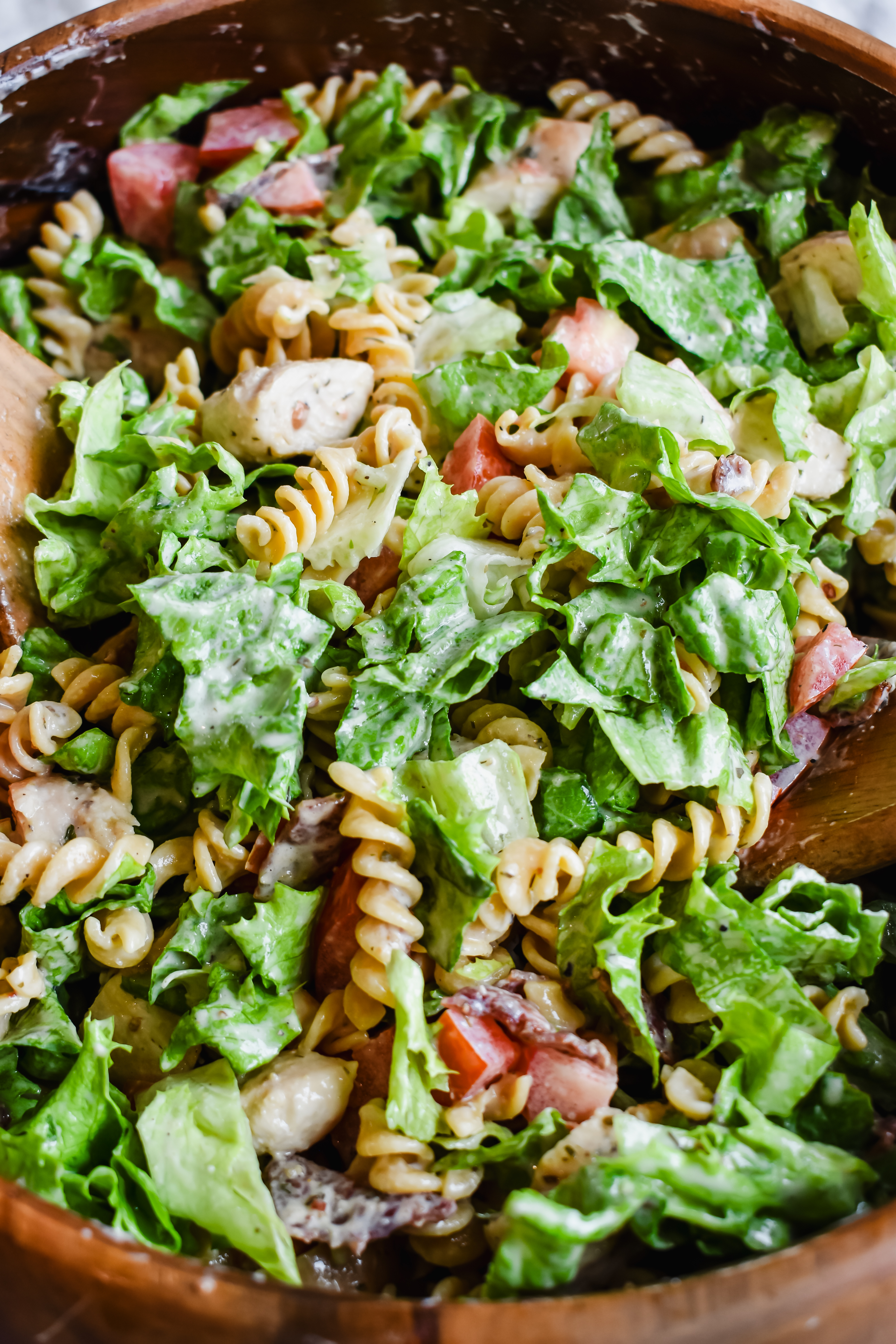this is a side view close up of the blt chicken pasta salad after it had been tossed.