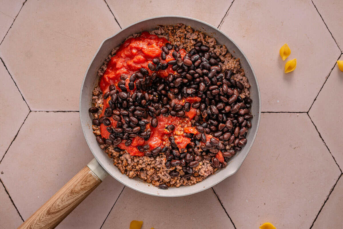 this shows me adding the tomatoes and beans